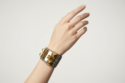 Delicate hand wearing Hermes Lizard CDC Cuff