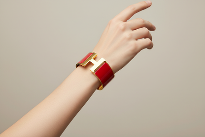 Hand wearing Hermes Rouge Clic Clac H Bracelet