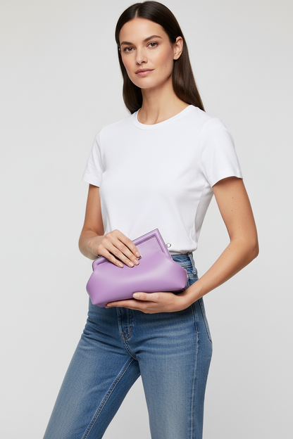 Model holding Fendi First Lilac bag as a clutch